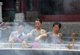 China: Lighting incense at Hongfu Si (Hongfu Temple), Qianling Shan Park, Guiyang, Guizhou Province